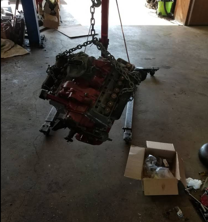 Engine on hoist during teardown and rebuild
